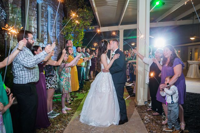 Graysen wedding ceremony in Comfort reception sparkler exit kiss