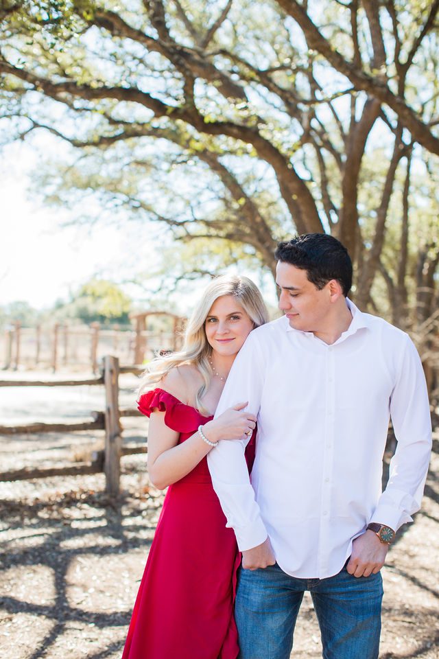 Heath's Engagement session Cibolo Natural Area by the fence snuggling