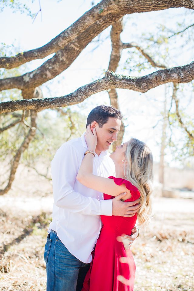 Heath's Engagement session Cibolo Natural Area under the tree in red