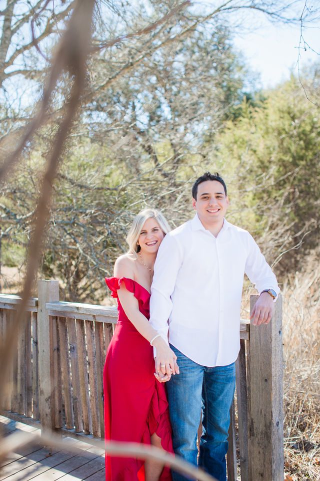 Heath's Engagement session Cibolo Natural Area on the bridge laughing
