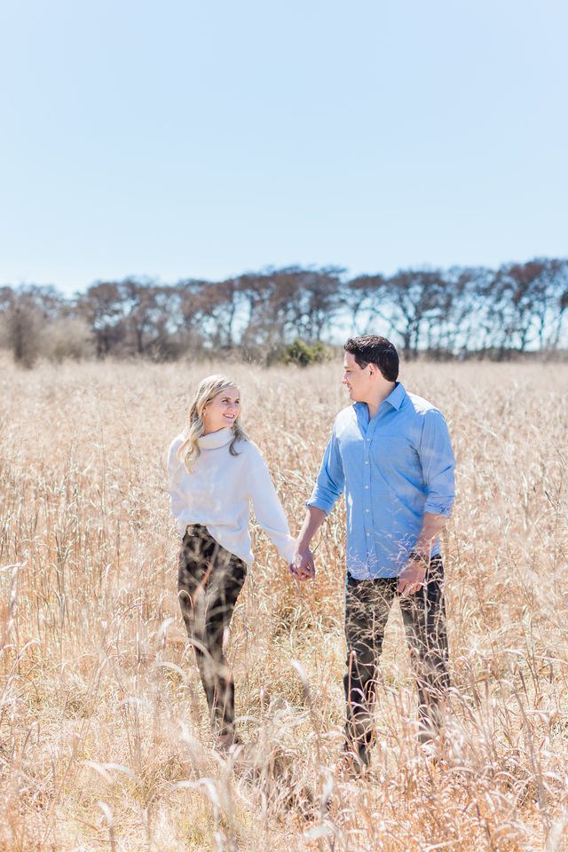 Heath's Engagement session Cibolo Natural Area walking in the grass