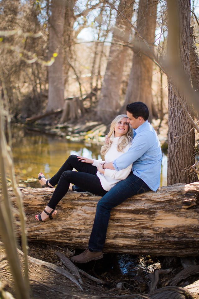 Heath's Engagement session Cibolo Natural Area sitting on the log