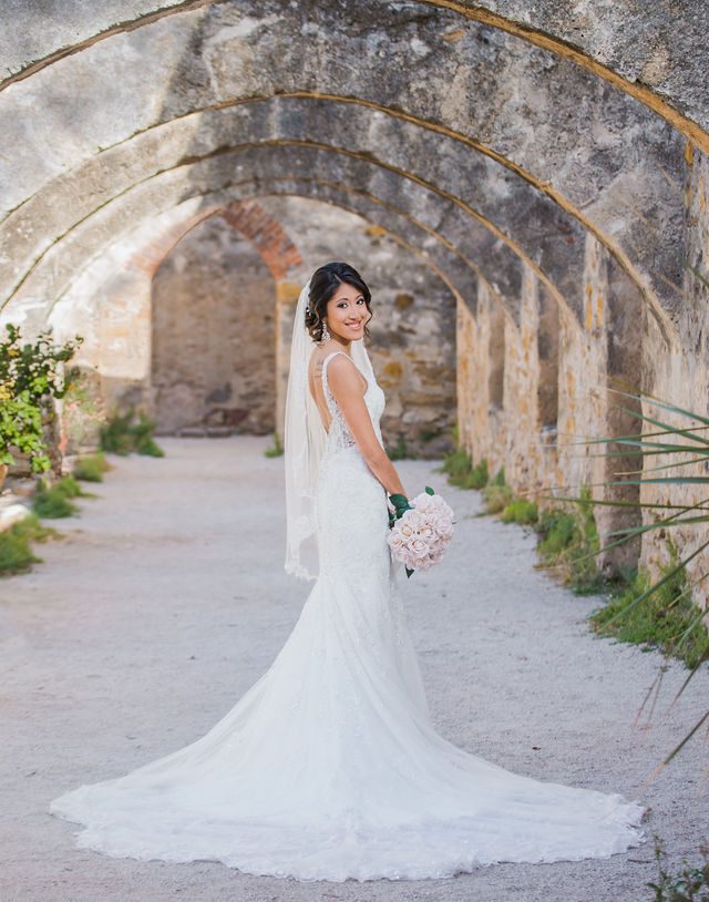Kylee's bridal at Mission San Jose in the arches with her train