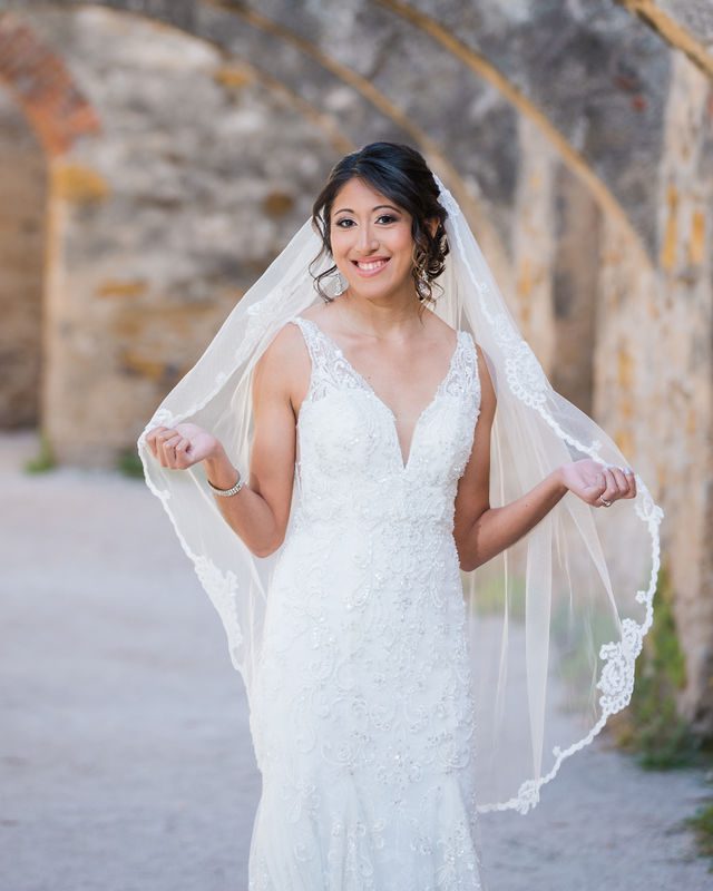 Kylee's bridal at Mission San Jose in the arches holding the veil