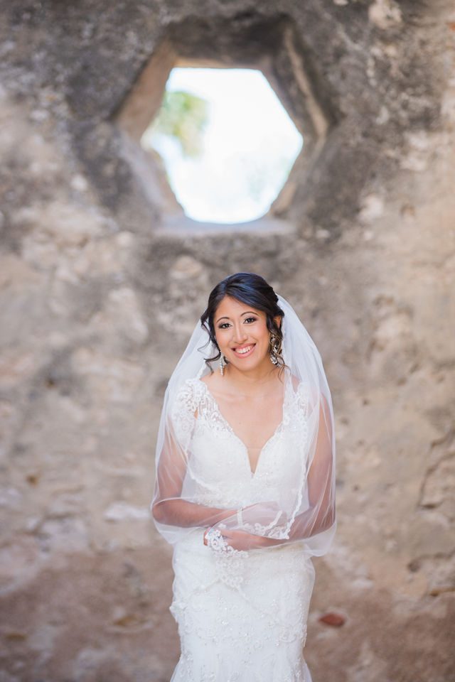 Kylee's bridal at Mission San Jose holding octagon window