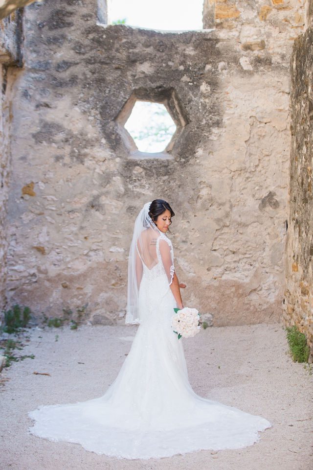 Kylee's bridal at Mission San Jose back of gown portrait at octagon window