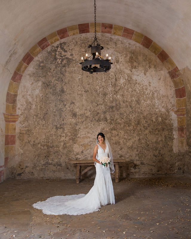 Kylee's bridal at Mission San Jose bride with granary wall