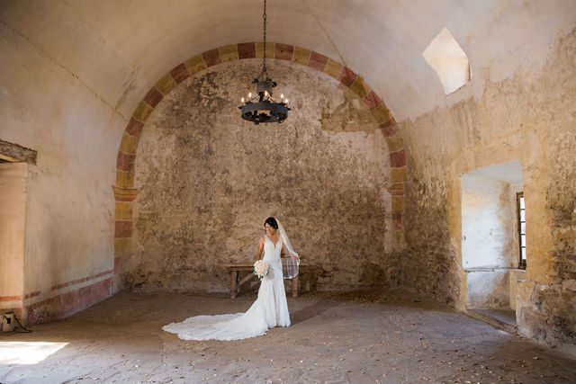 Kylee's bridal at Mission San Jose bride with granary wall full room