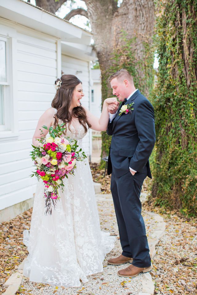 Simon wedding at Gruene Estate in New Braunfels couple's first look hand kiss