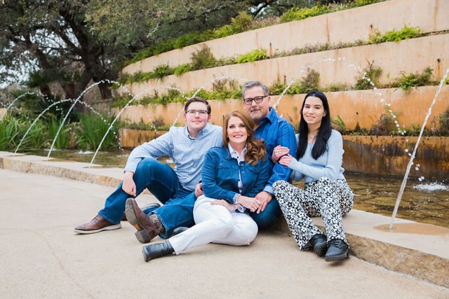 Deborah's family engagement at San Antonio Botanical Gardens sitting at the fountain