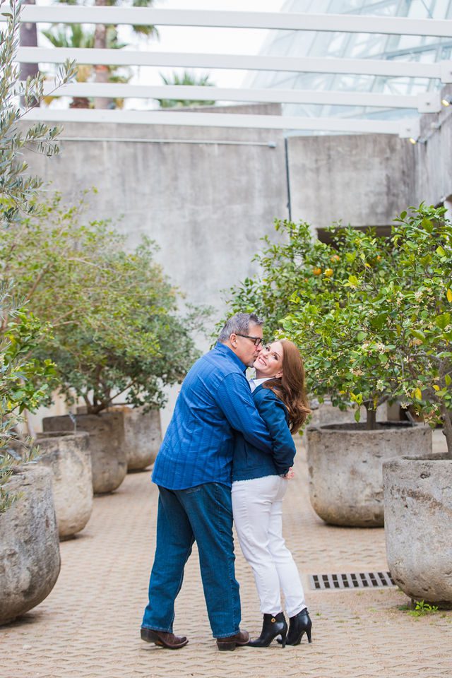 Deborah's engagement at Botanical Gardens couple walking in the orangery laughing