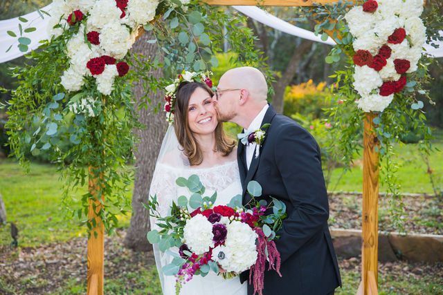 Pixley wedding in Garden Ridge groom kiss the bride portrait