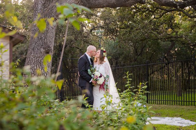 Pixley wedding in Garden Ridge bride and groom kissing under the tree