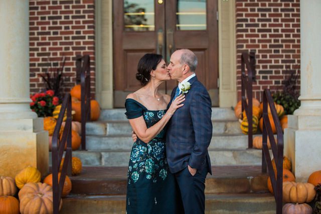 Sharon wedding in New Braunfels at McAdoos couple kiss on front porch with pumpkins