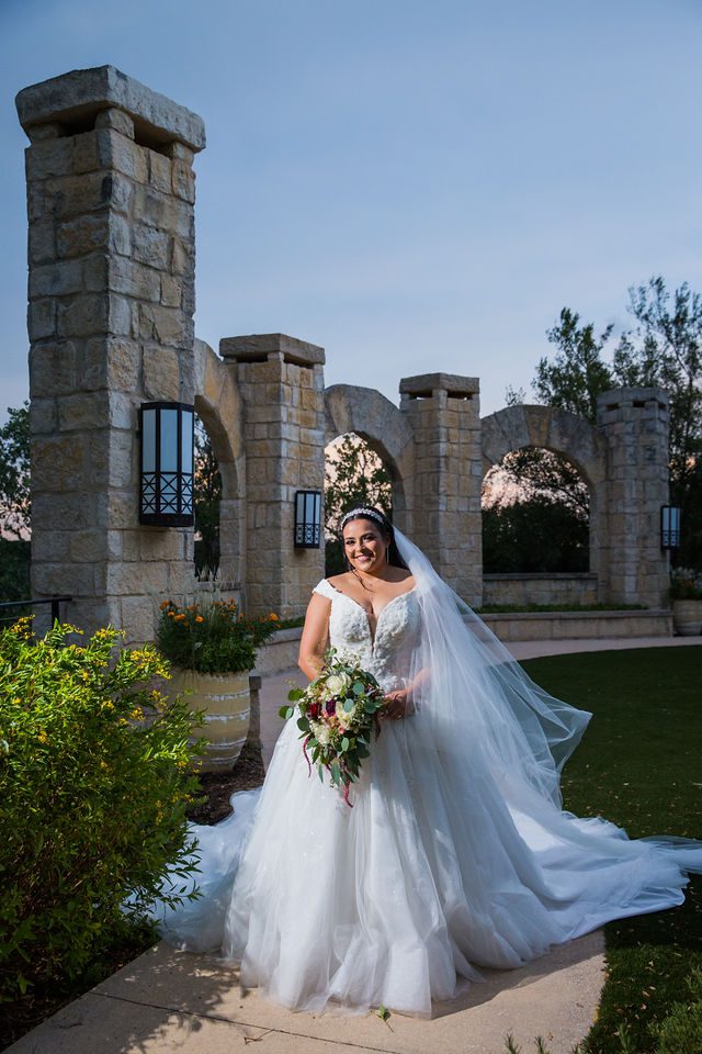 Ebonee's bridal at La Cantera portrait beside the arches at sunset