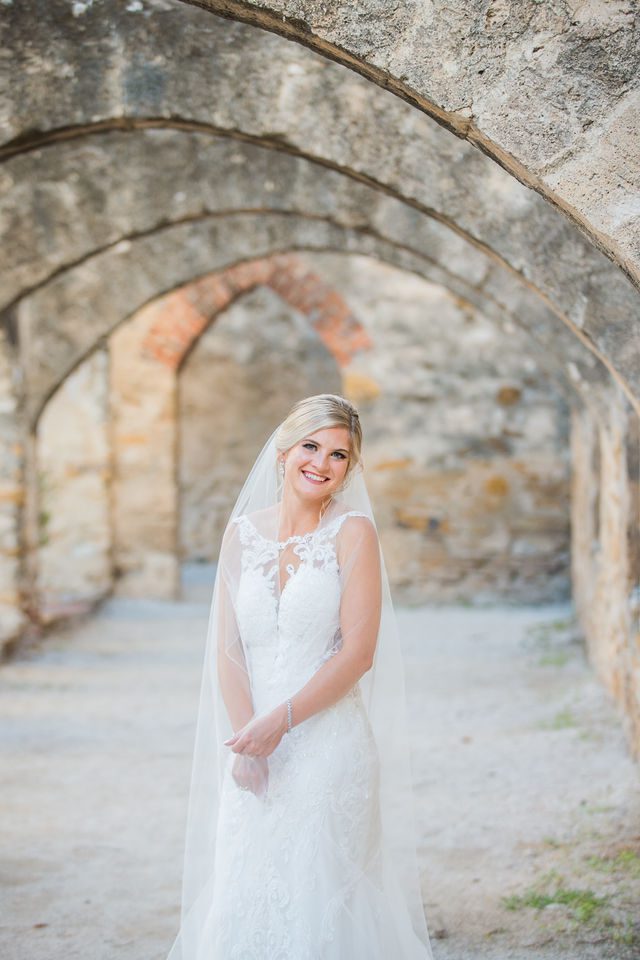 Jennifer's bridal headshot with veil in the arches at Mission San Jose