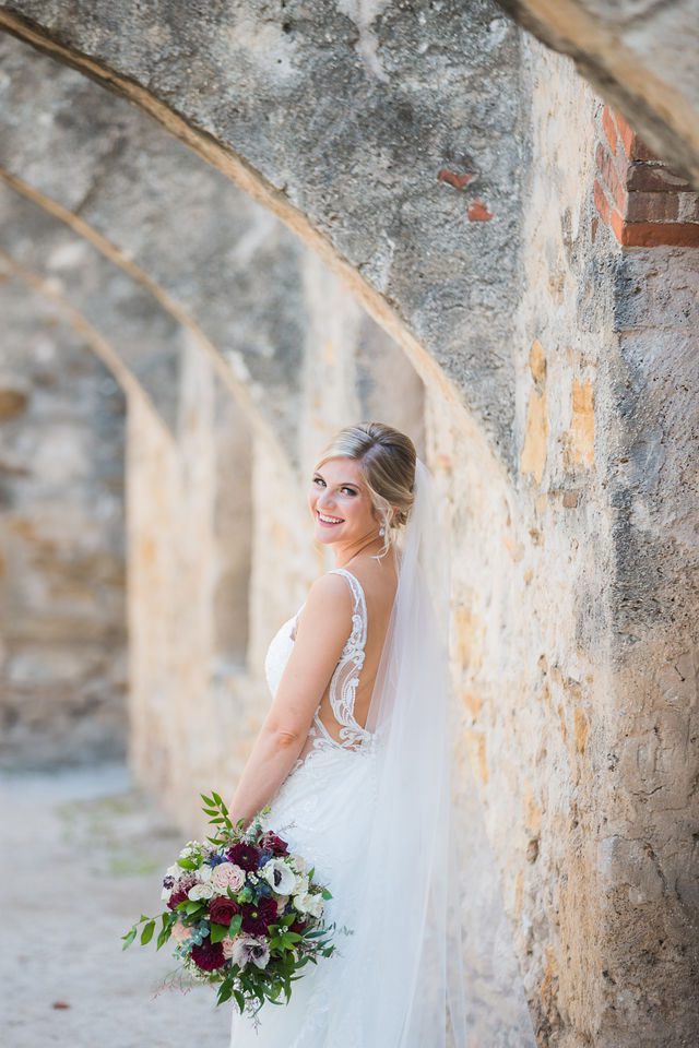 Jennifer's bridal with veil in the arches at Mission San Jose looking back
