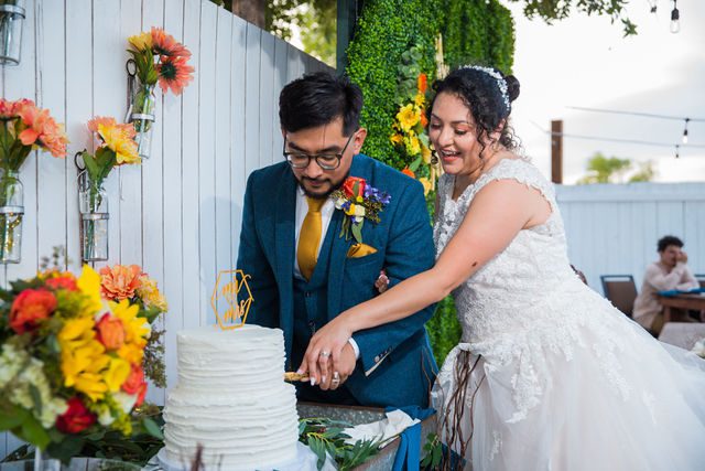 The Cruz-Martinez wedding in San Antonio reception cake cutting laughing