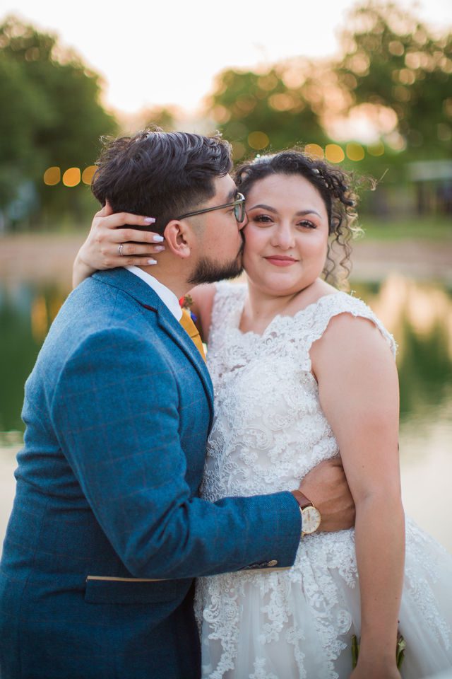 The Cruz-Martinez wedding reception in San Antonio sunset kiss by the lake