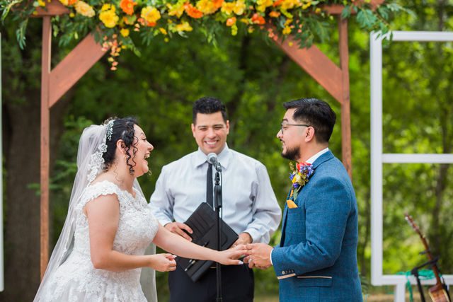 The Cruz-Martinez wedding in San Antonio bride laughing at the ceremony