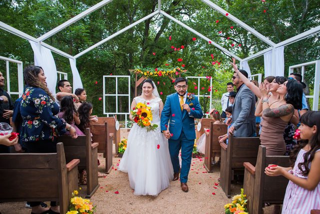 The Cruz-Martinez wedding in San Antonio ceremony exit with flowers