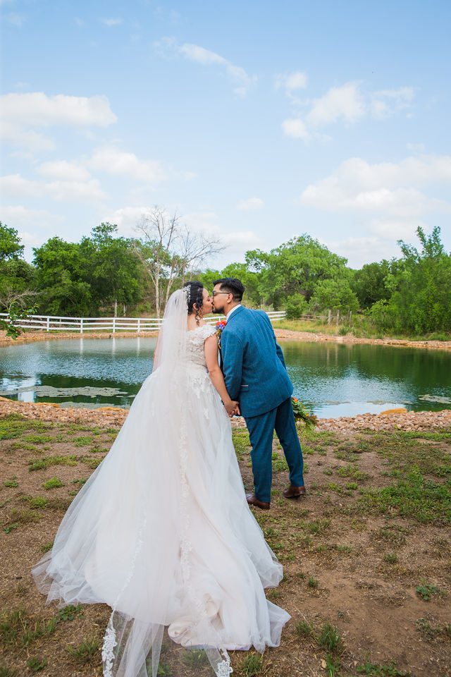 The Cruz-Martinez wedding in San Antonio couple walking by the pond