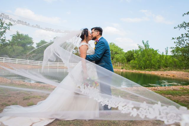 The Cruz-Martinez wedding in San Antonio couple with veil.