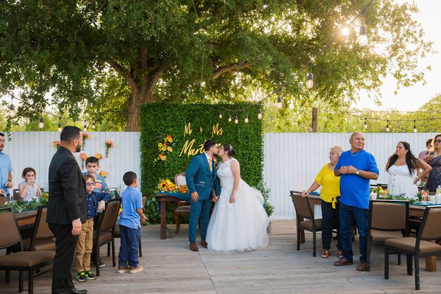 The Cruz-Martinez wedding in San Antonio reception couple entrance kiss