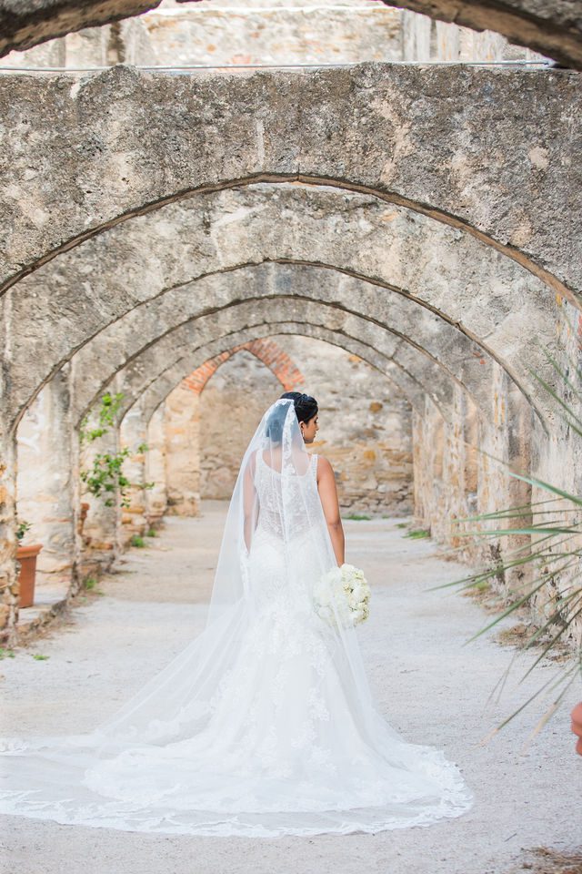 Sonali's bridal portrait in the arches of Mission San Jose back of wedding gown