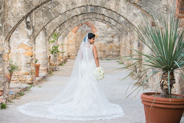 Sonali's bridal session in the arches of Mission San Jose back of wedding gown
