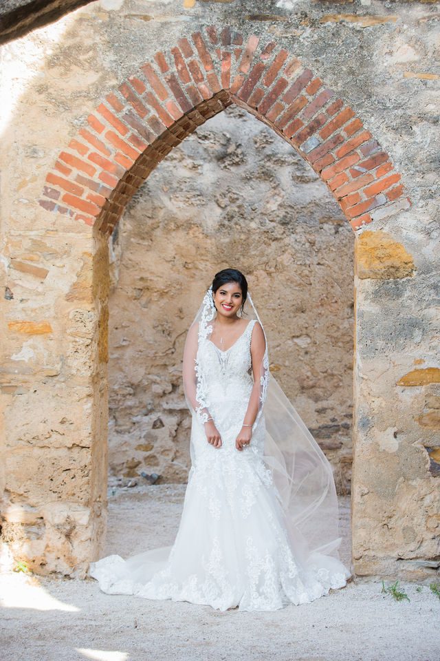 Sonali's bridal session in the doorway arch of Mission San Jose veil