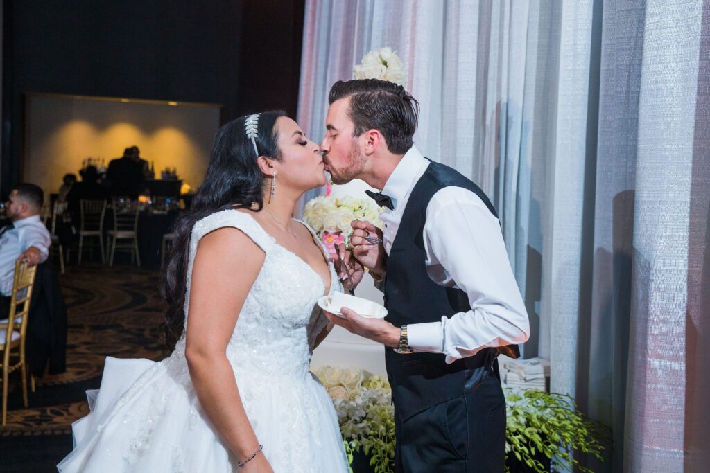 Ebonee wedding reception at La Cantera cake cutting kiss