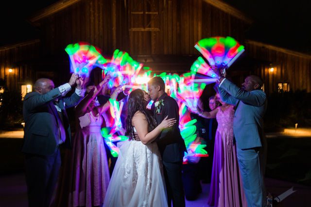 Hall wedding at Chandelier of Gruene the reception exit kiss with LEDs