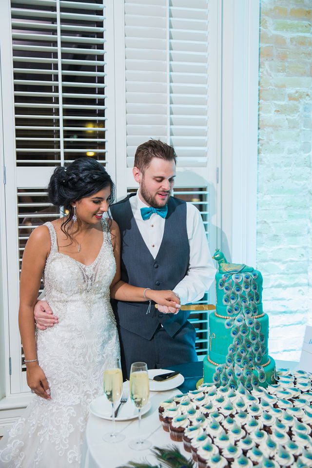 Sonali's wedding at Hotel Valencia reception cutting the cake