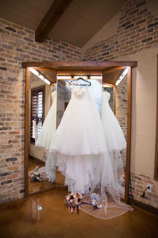 Weyand wedding at the Chandelier of Gruene getting ready the bride's gown