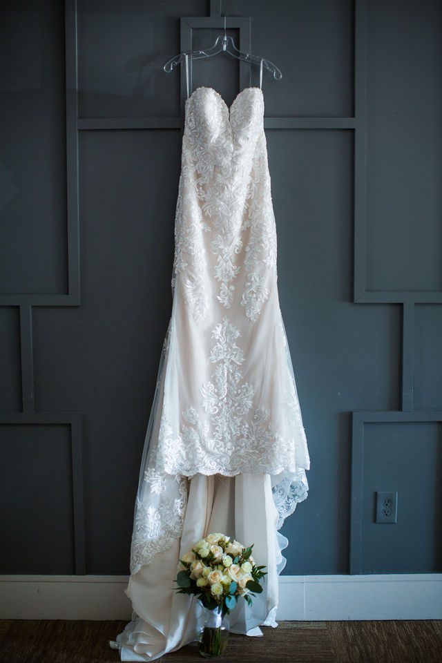 Tate wedding Olympia Hills dress hanging on the wall