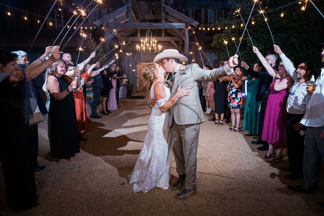 Lamm wedding reception at Eagle Dancer Ranch exit kiss