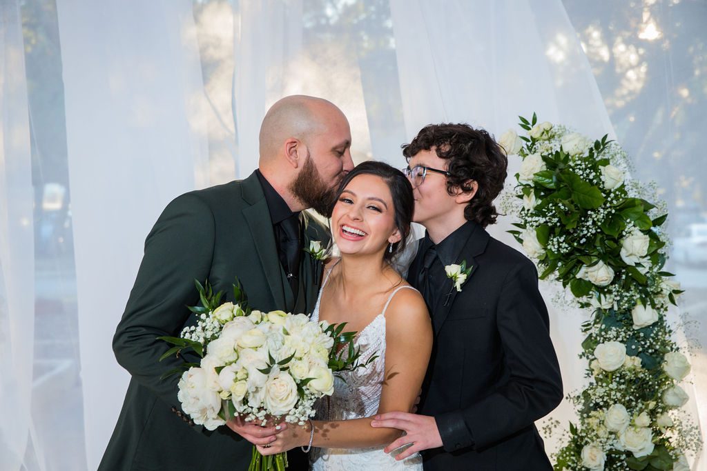 Navarro's wedding at the Dominion country club family portrait kiss