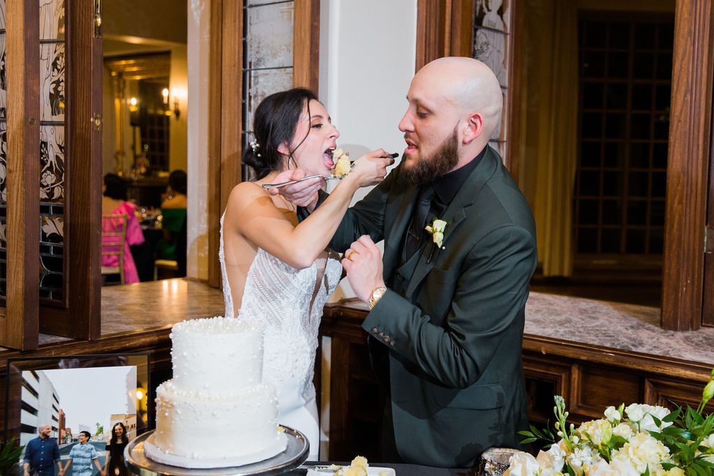 Navarro's wedding at the Dominion country club reception cake cutting feeding
