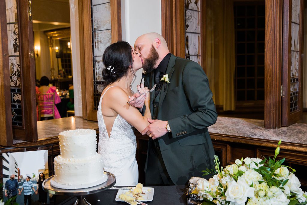 Navarro's wedding at the Dominion country club reception cake cutting kissing