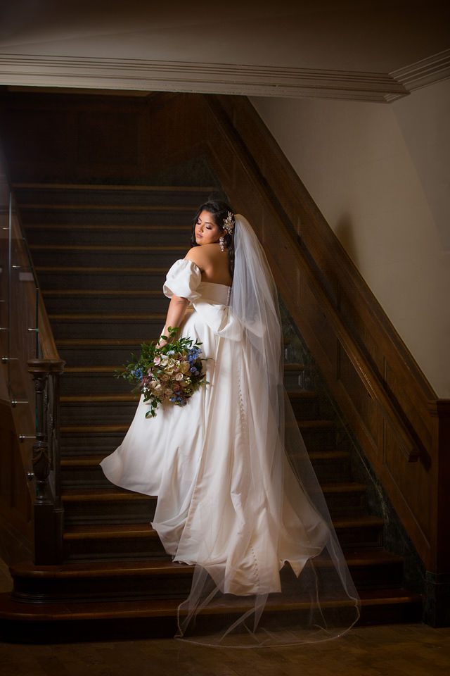 Maddie's bridal at The Briscoe in San Antonio on the bottom stairs