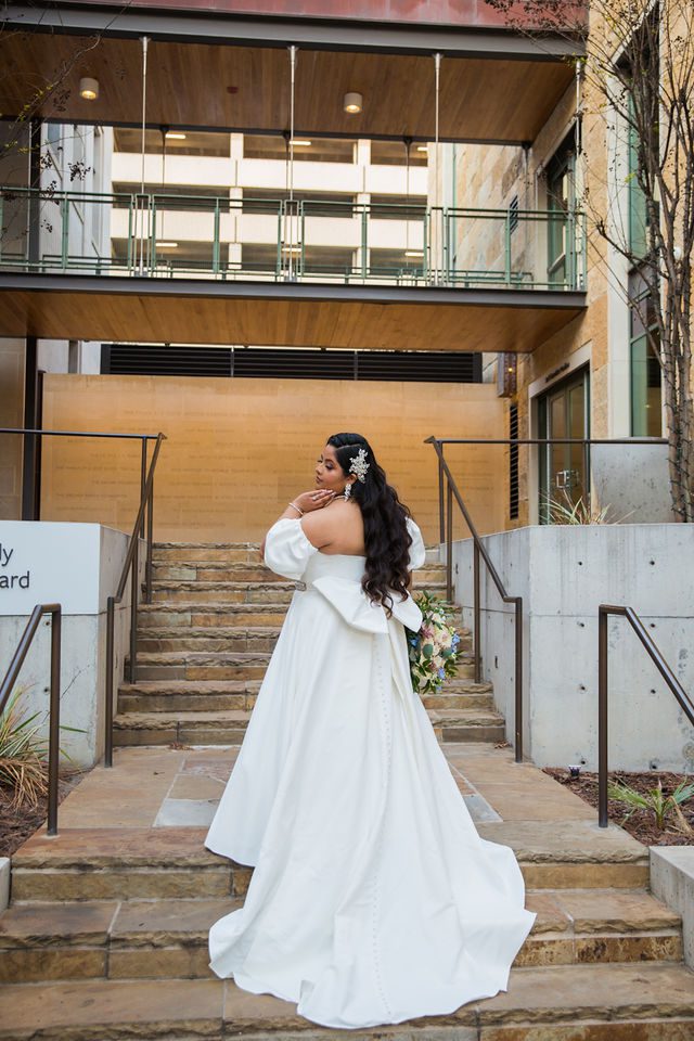 Maddie's bridal at The Briscoe in San Antonio on the gallery steps back of gown