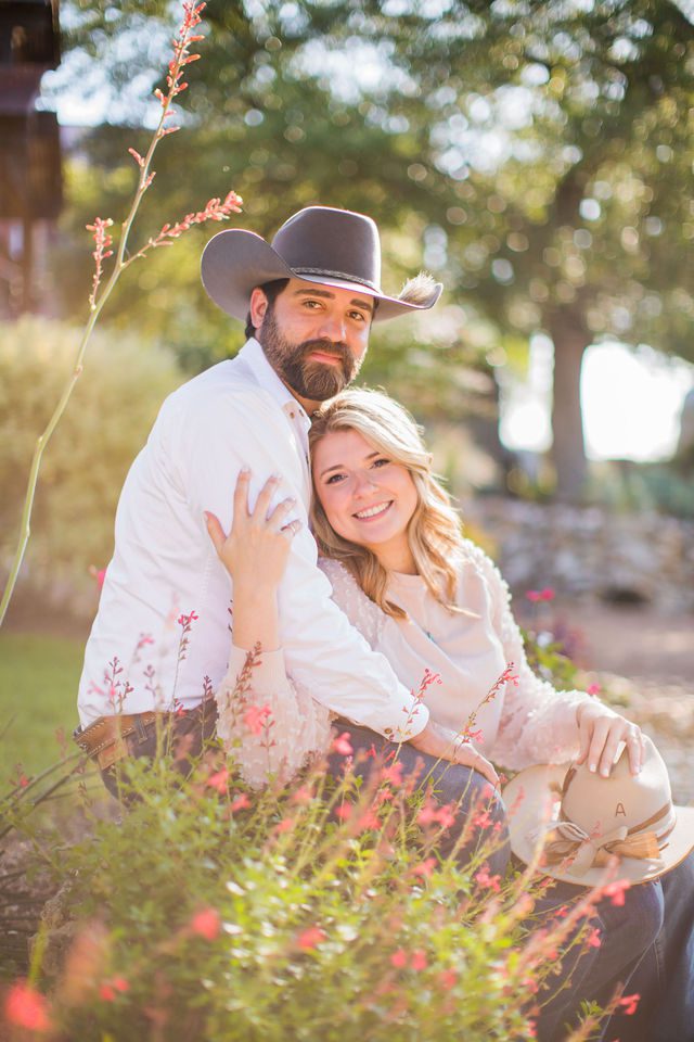 Bendele engagement at Eagle Dancer Ranch seated with flowers