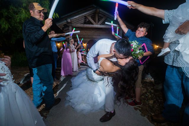 Hollubs wedding at Geronimo Oaks in San Antonio reception exit kiss