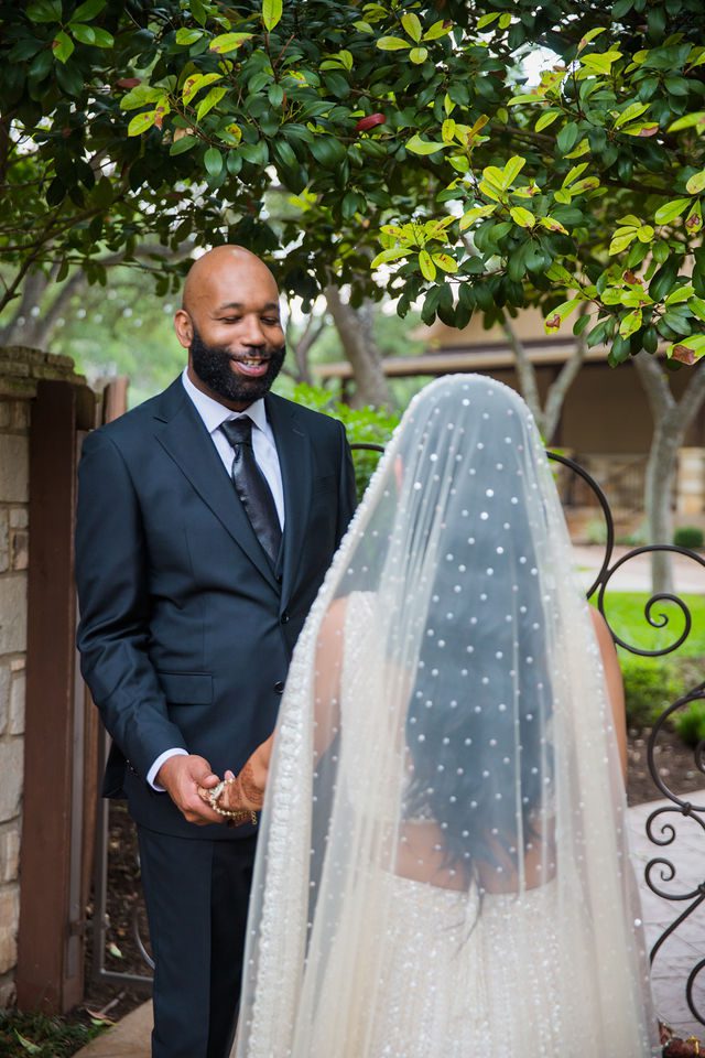 Nida wedding Club of Garden Ridge in San Antonio by the gate groom turned for first look