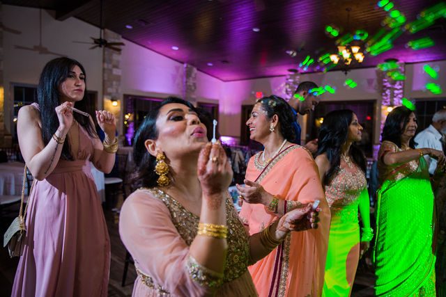 Nida wedding reception Club of Garden Ridge in San Antonio bridesmaid blowing bubbles