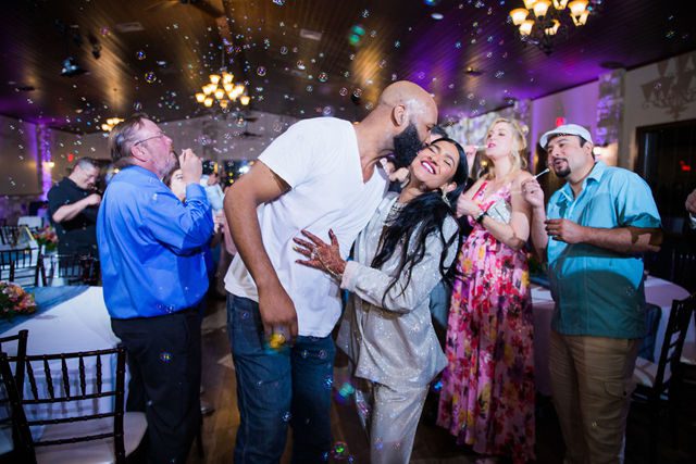 Nida wedding reception Club of Garden Ridge in San Antonio bubble exit kiss