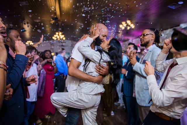 Nida wedding reception Club of Garden Ridge in San Antonio exit kiss
