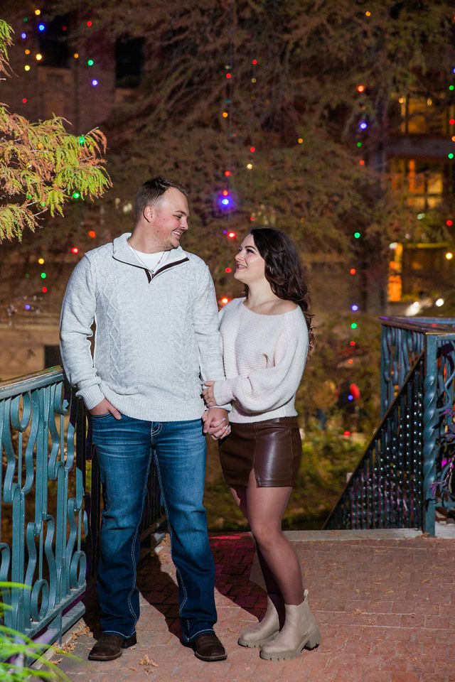 Ashlyn engagement in San Antonio on the balcony on the riverwalk holding hands