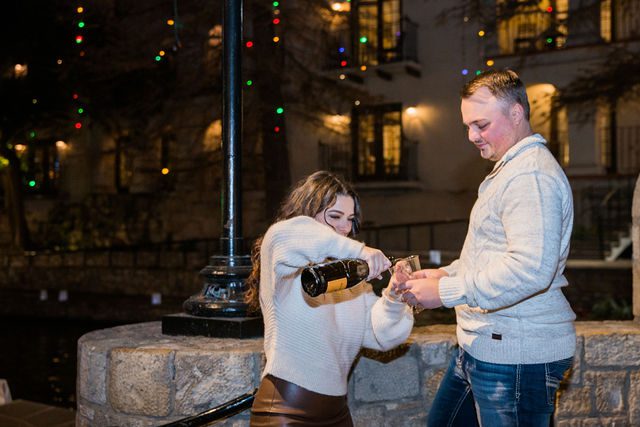 Ashlyn engagement in San Antonio on the bridge pouring the champagne